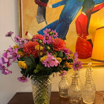 Custom floral arrangement featuring buddleja, cosmos and dahlias in an upcycled crystal vase styled with the interior artwork