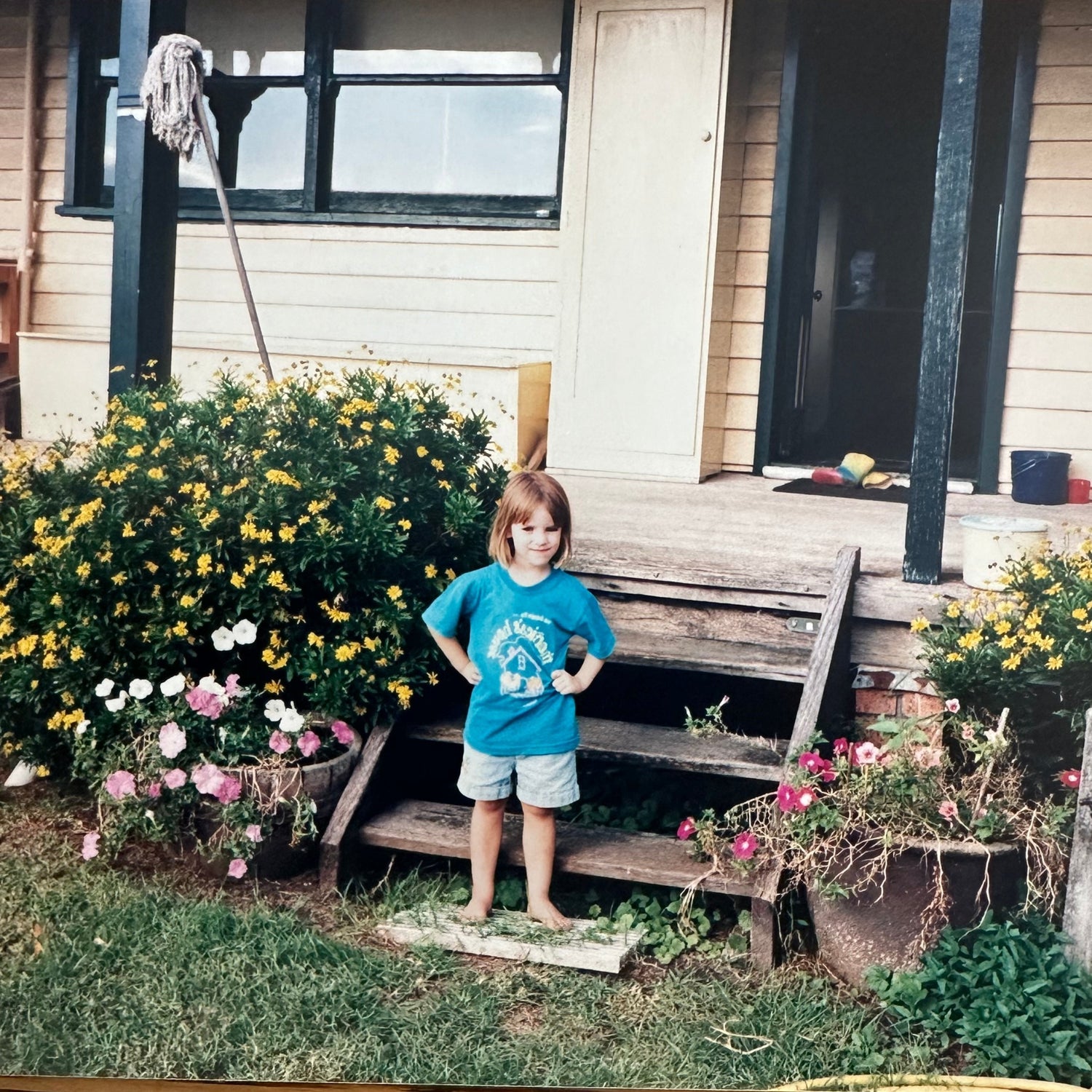 Standing on the steps of my grandparent's house in Mount Vincent by the flowers