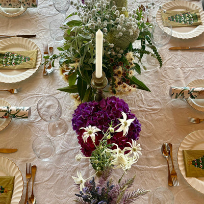 Elegant dining table setting with floral centerpiece and place settings.