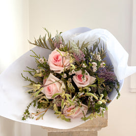 Bouquet of Australian grown pink roses and greenery on a white background