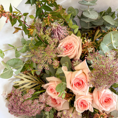 Bouquet of Australian grown pink roses and greenery on a white background
